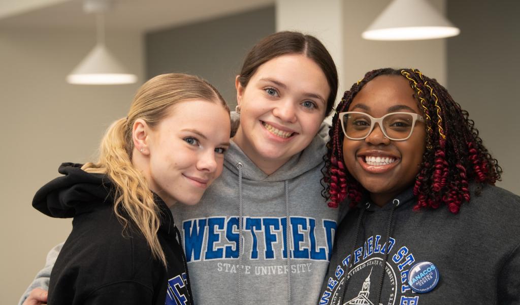 Three students smiling wearing 91ɫ State sweatshirts.