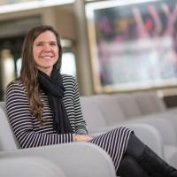 Bethany Mather, a teacher at Farmington River Regional School and alumna of 91ɫ, was recently named this year’s Massachusetts University Educator Alumni Award recipient. She's sitting in the lobby at Horace Mann, in a gray chair. An unfocused window is behind her.
